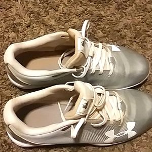 Kids silver and white Under Armour baseball cleats